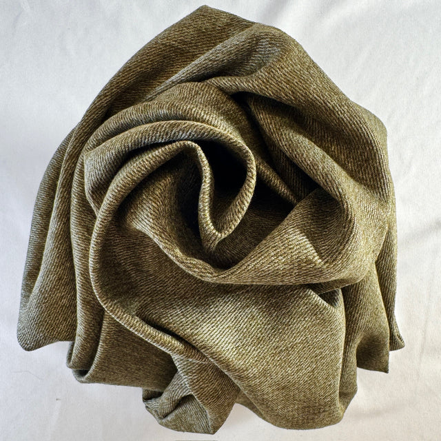 Olive hemp twill scrunched in a spiral on white background