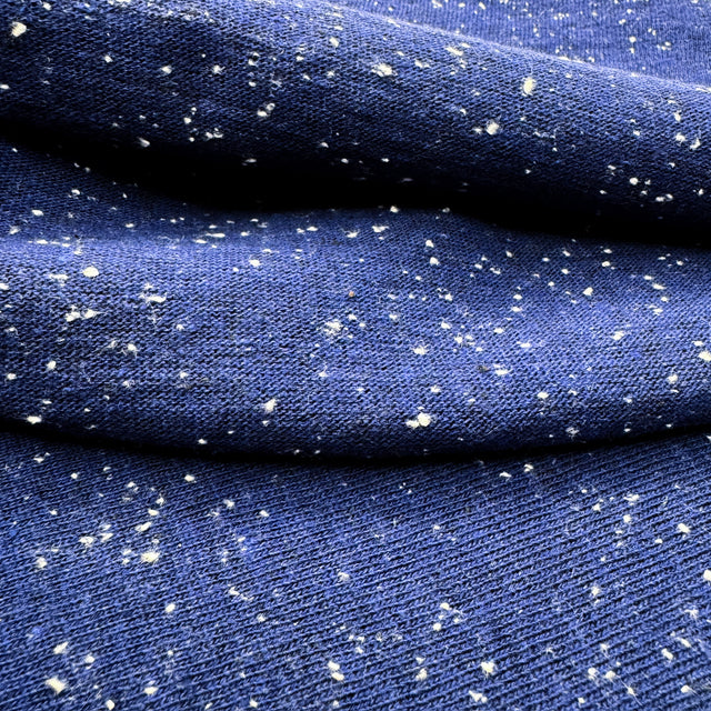 Blue jersey with white speckles shown in close-up on both sides