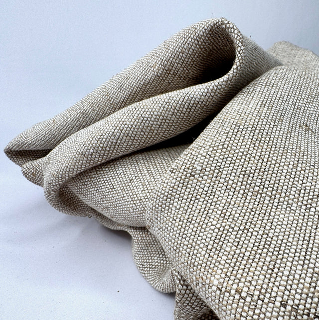 Folded textured fabric on a light gray background