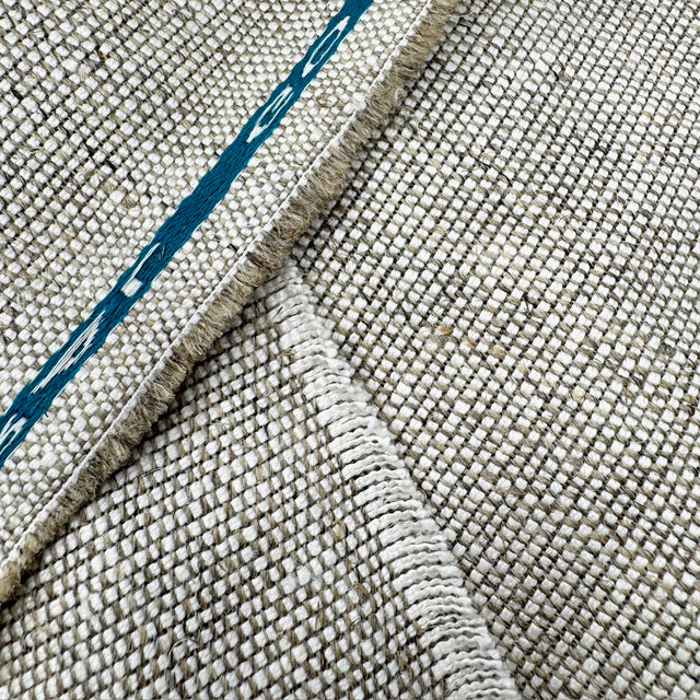 Close-up of textured fabric with a blue line running through it