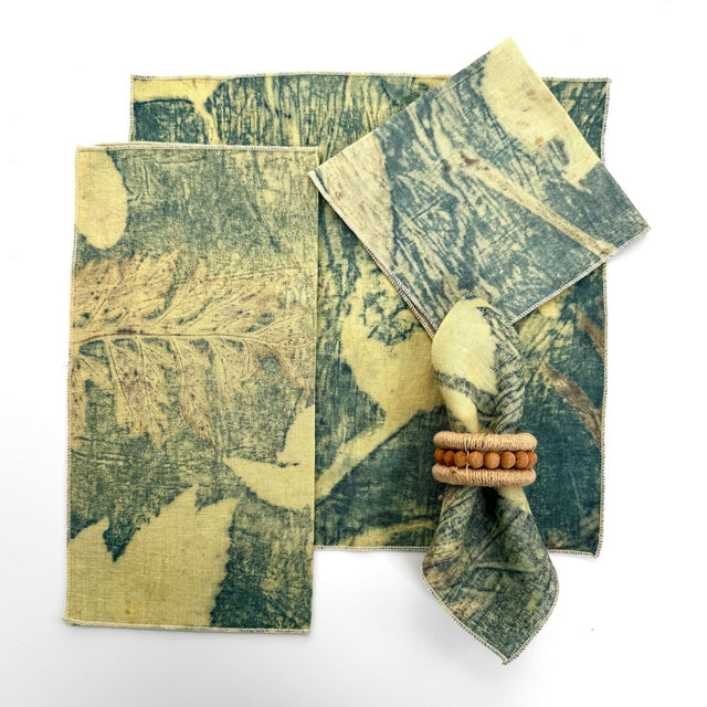 100% hemp red eco print color table napkin pictured with 5 different ways to fold the napkin.  Napkins have black threading on the edge.