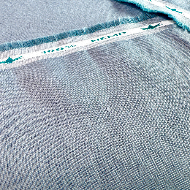 Close-up of blue hemp fabric with '100% Hemp' label