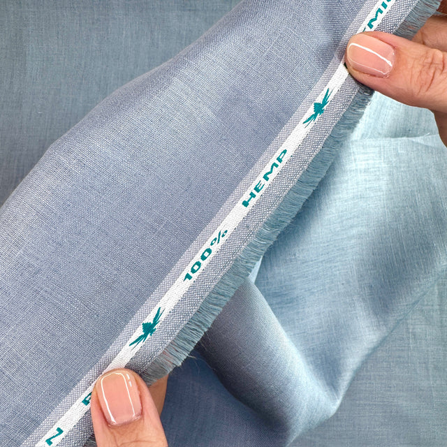 Close-up of blue fabric with a label indicating 100% hemp.