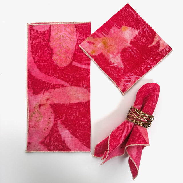 100% hemp red eco print color table napkin pictured with 3 different ways to fold the napkin.  Napkins have black threading on the edge.