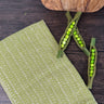 Lime Green and white honeycomb design dish towel - hand woven hemp and cotton blend.  Pictured on a brown table with snap peas and a wooden cutting board.