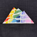 rainbow triangular folded  fabric pocket square on a dark textured background