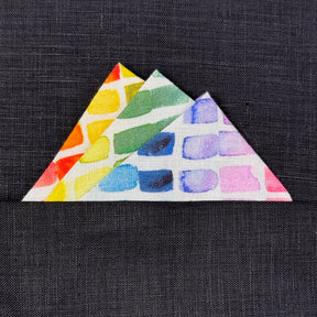 rainbow triangular folded  fabric pocket square on a dark textured background