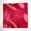 red fabric with leaf pattern on a white background