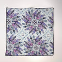 textile with geometric feather pattern featuring purple and blue colors on a white gray background.