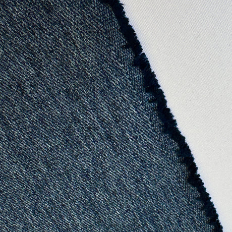 Close-up of denim fabric with a white background
