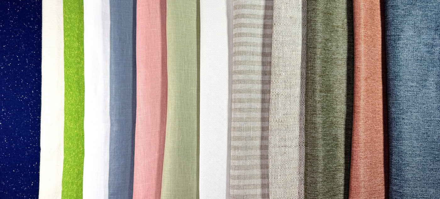 Stripes of various fabric textures and colors arranged in a row.