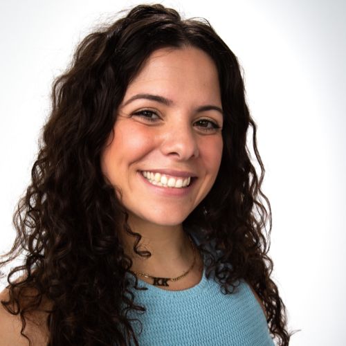 profile picture of Lauren Miele wearing a blue tank top.  she is wearing her hair down and draped over her shoulders.