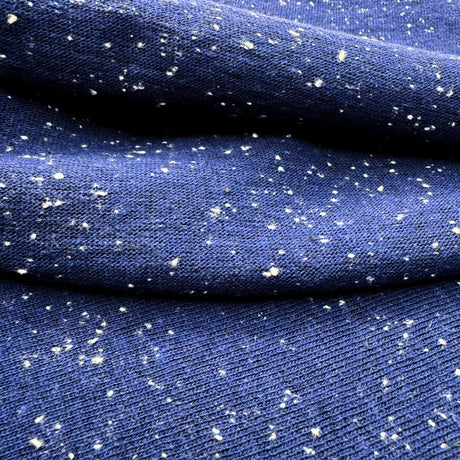 Blue jersey with white speckles shown in close-up on both sides
