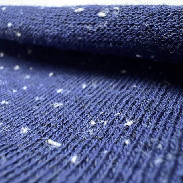 Close-up of blue textured fabric with white specks