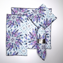 purple and blue geometric feather designed napkins folded in various arrangements