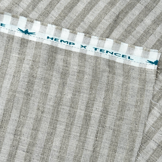 Textile with 'Hemp x Tencel' label on a striped fabric
