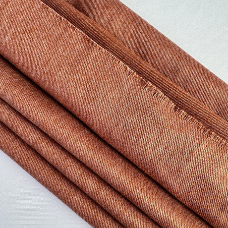 Terra Cotta hemp twill layered on an angle on a white background