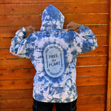 Indigo tie dye hoodie with a the words "free the people, free the plant de-schedule it" screen-printed on the back.  Model is standing with the back viewable only, hood on.