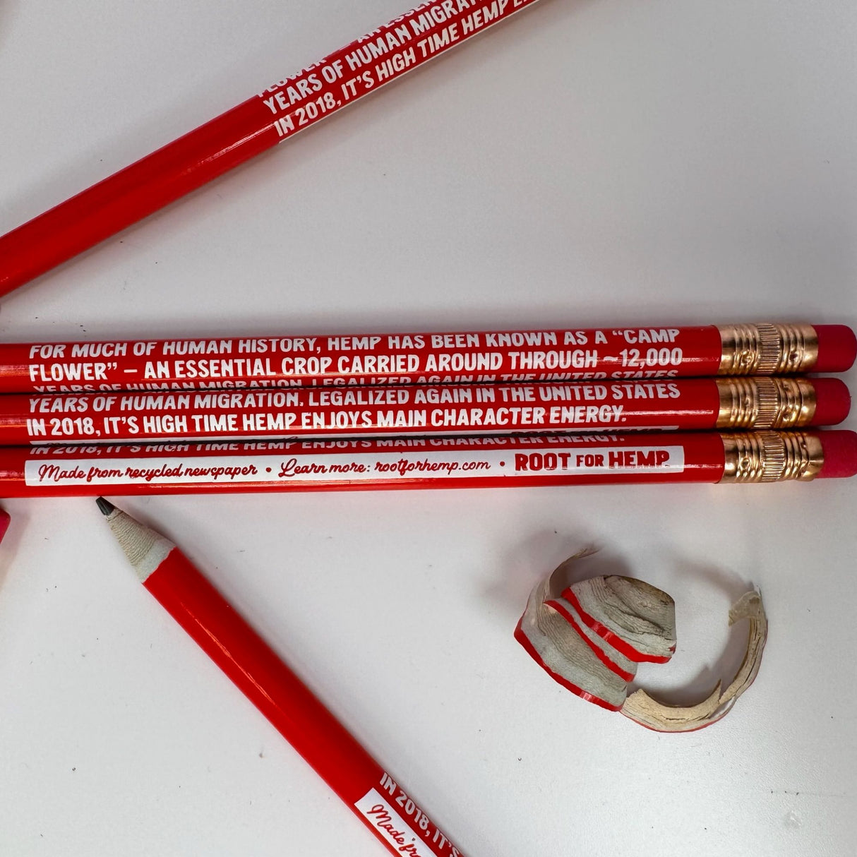 5 red pencils with hemp educational statement printed on them in white font.  pencils have red erasers