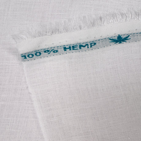 Close-up of white fabric with a '100% Hemp' label.