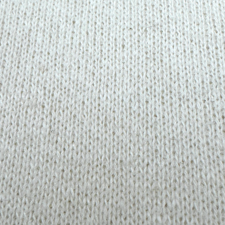 Close-up of a textured cream fabric surface
