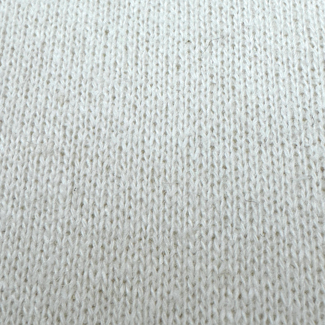 Close-up of a textured cream fabric surface