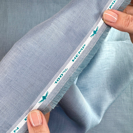 Close-up of blue fabric with a label indicating 100% hemp.