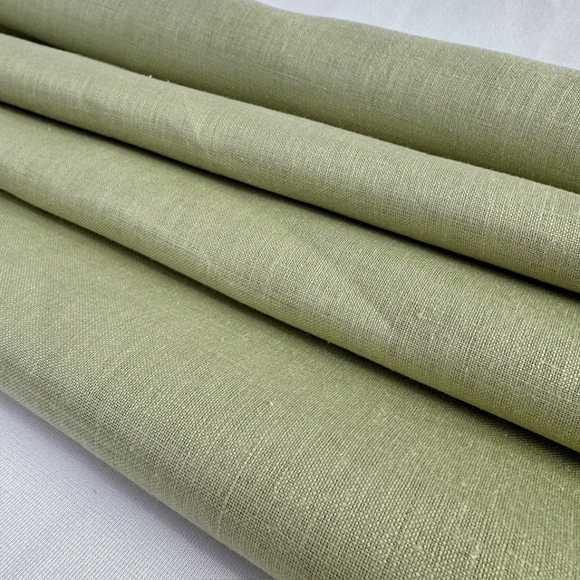 Folded green fabric on a white background