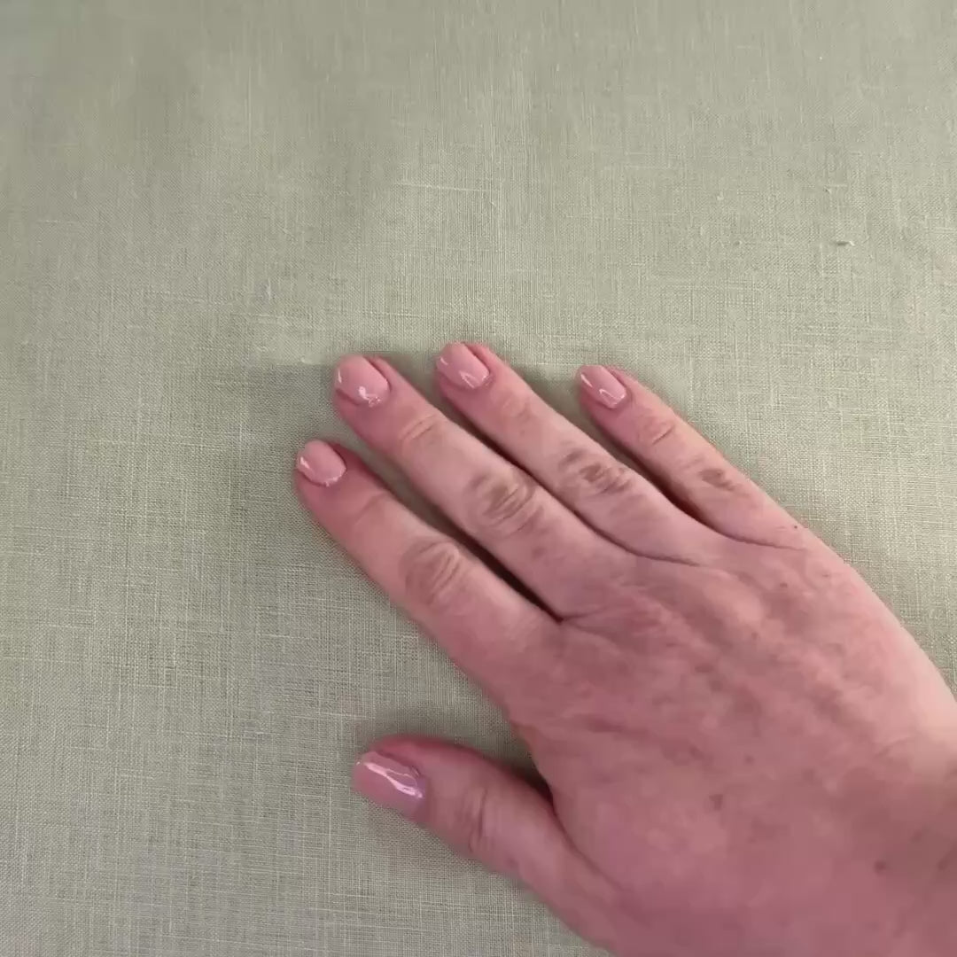 lightweight light sage hemp linen shown with hands and scrunched