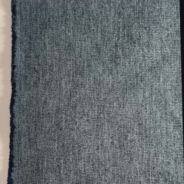 Blue denim hemp twill shown with hands, folded and scrunched