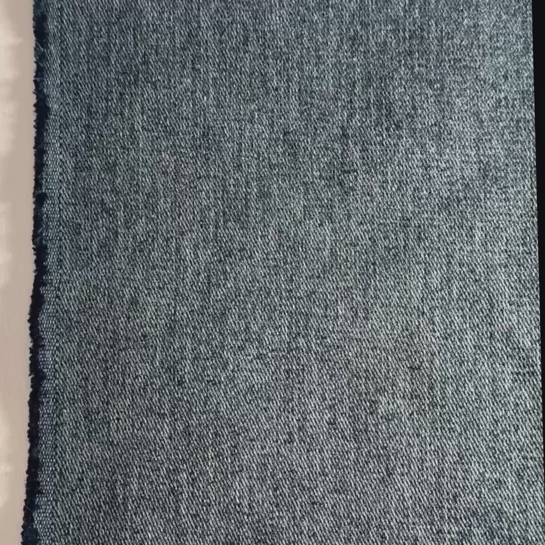 Blue denim hemp twill shown with hands, folded and scrunched