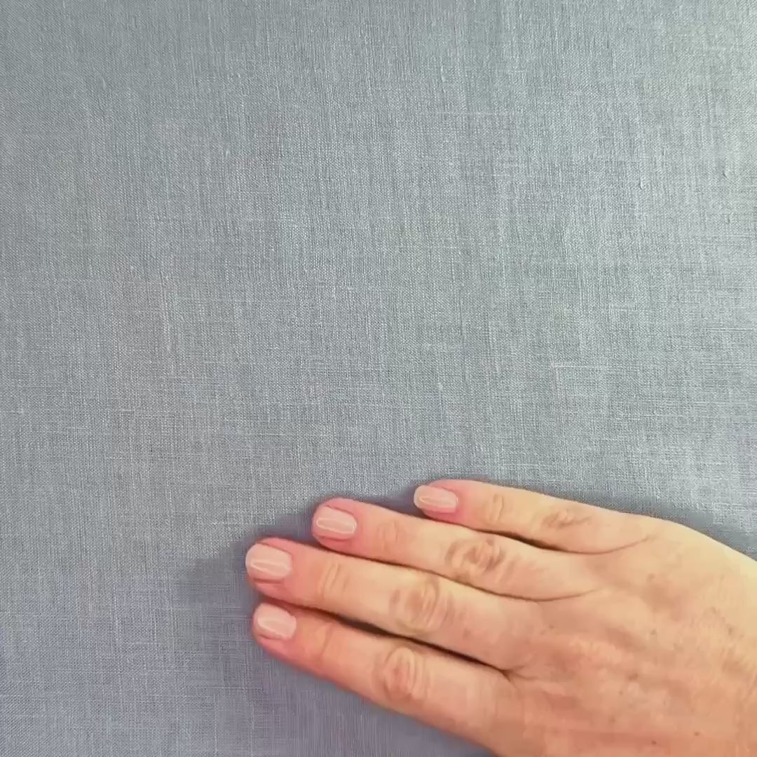 lightweight light blue hemp linen shown with hands and scrunched