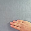 lightweight light blue hemp linen shown with hands and scrunched