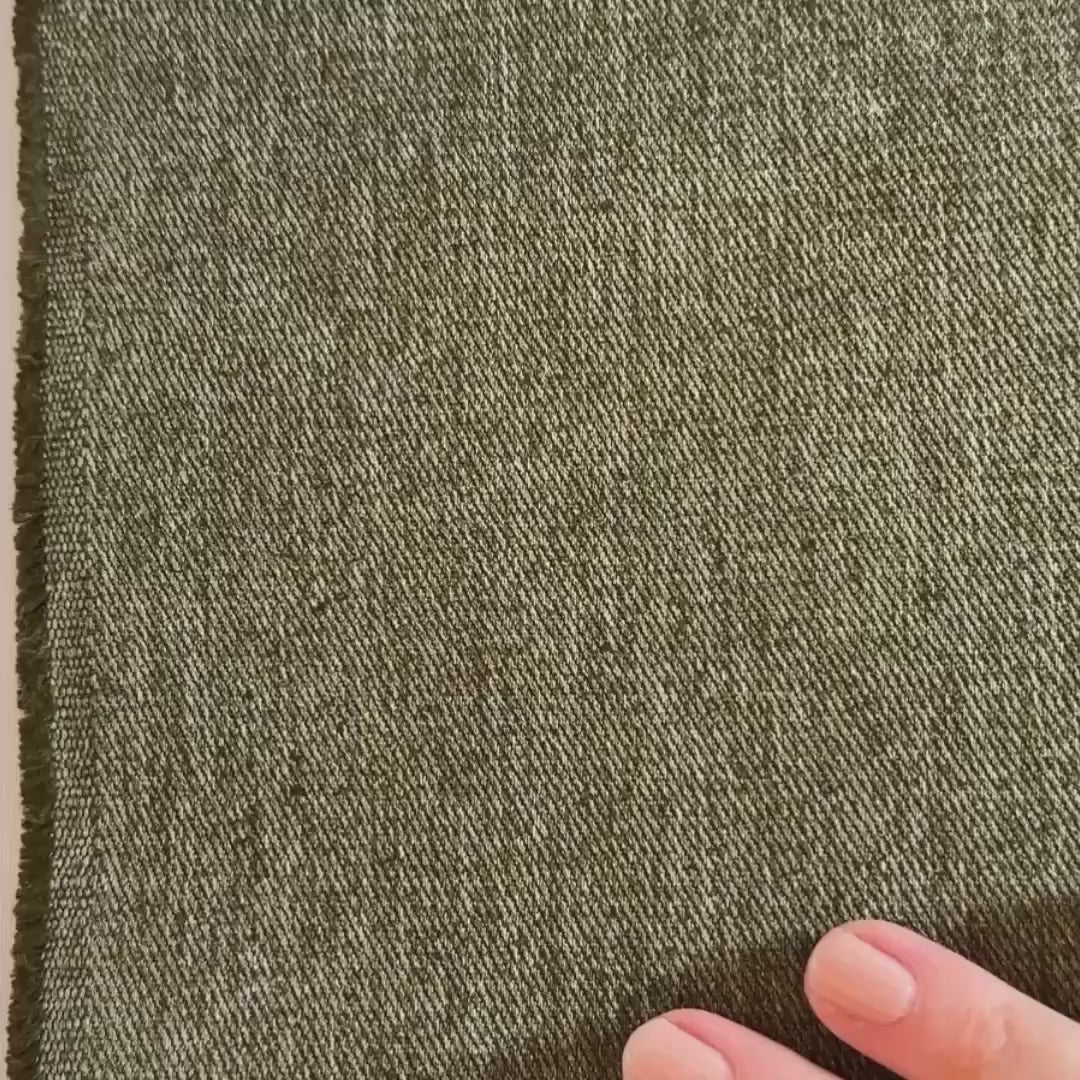 Olive twill hemp fabric shown with hands and scrunched