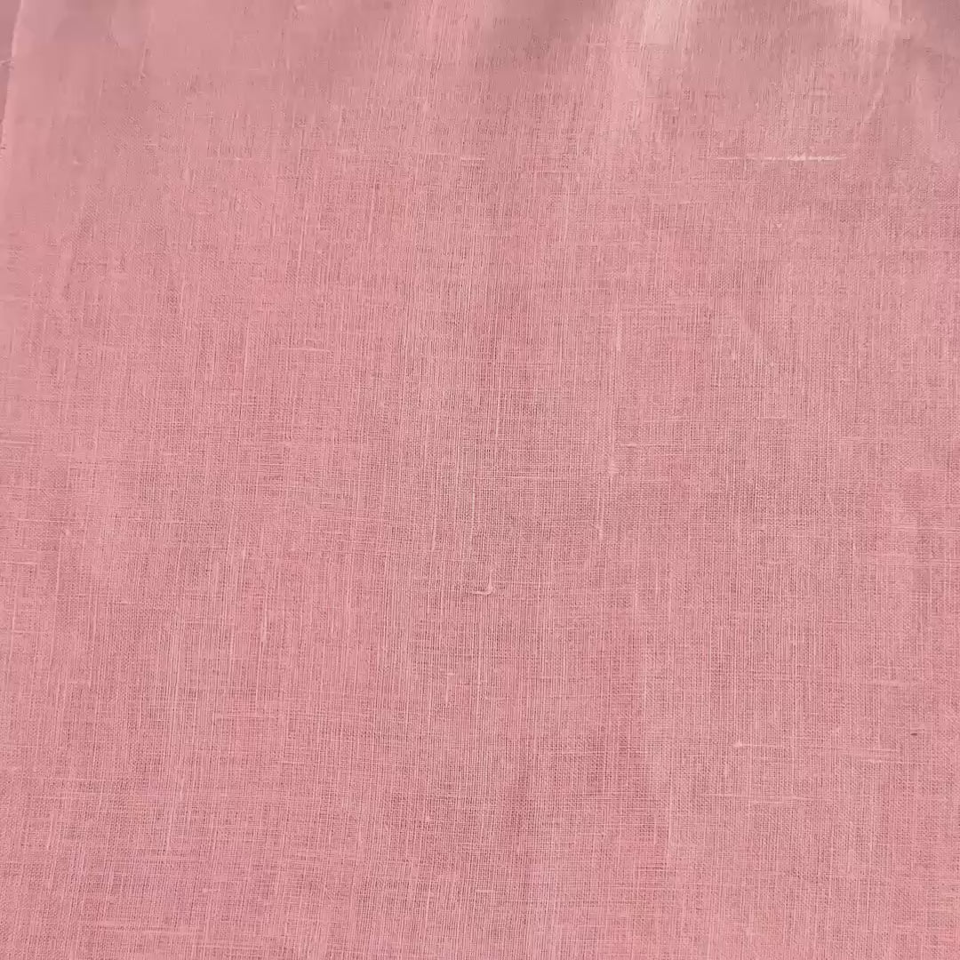 lightweight light pink hemp linen shown with hands and scrunched