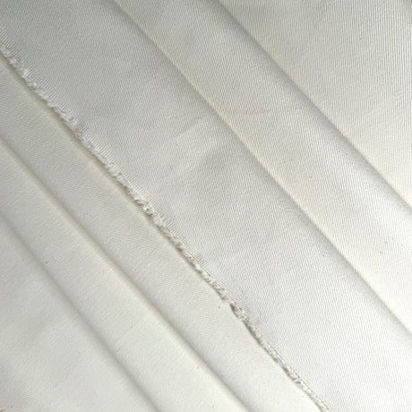 Close-up of cream twill fabric with visible texture