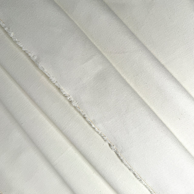 Close-up of cream twill fabric with visible texture