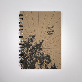 A spiral-bound sketchbook with a natural cover featuring a black illustration of hemp plants and the text 'Hemp Wonder Weed'.